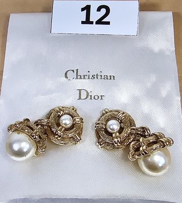 pair of christian dior earrings with pearls on display at a store