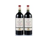 two bottles of red wine sitting next to each other on a white surface