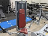 a gym with a lot of machines in the room