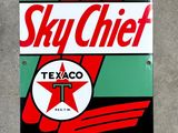 a sign that says sky chief gasoline on the side of a building