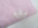 pink t - shirt with white adidas logo on it on a white surface