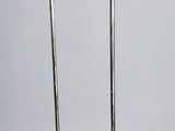 pair of chrome plated floor lamps on a white background
