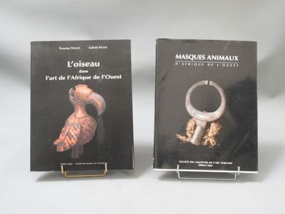 two books on a table with a white background and a black cover