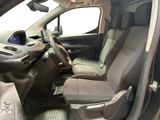 the interior of a car with the door open and the driver ' s seat down