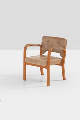 two wooden chairs with brown leather upholstered on a white surface