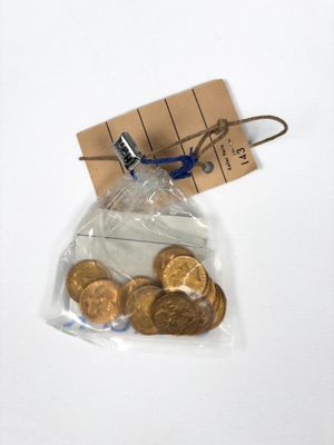 a bag of gold coins with a note attached to it