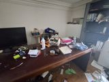 a messy desk with a computer on top of it
