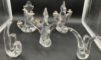 a glass candle holder that is sitting on a table
