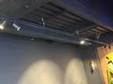 a picture of a room with a wall and ceiling lights