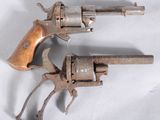 an old gun with a wooden handle on a white surface