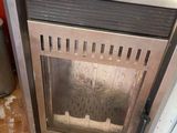 a stove that is sitting in the corner of a room