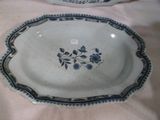 a blue and white plate with blue flowers on it