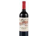 a bottle of red wine sitting on top of a white table
