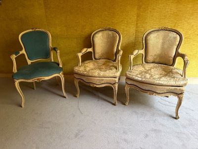 trois chaises dans une pièce aux murs jaunes, avec une chaise verte
