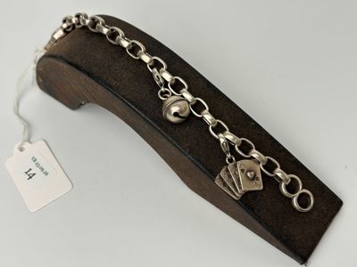 a close up of a metal bracelet with a tag on it