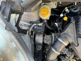 a close up of a car ' s engine with its hood open