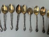 six spoons are lined up in a row on a table