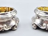 pair of silverplated salt and pepper shakers on a white background