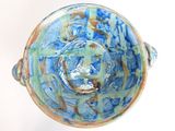 a close up of a blue and green bowl