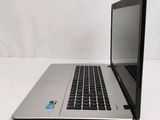 a laptop that is sitting on a table with a sticker on it