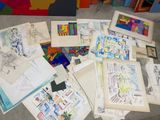 a lot of drawings on the floor next to each other