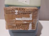a plastic container with a piece of cardboard on top of it