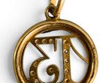 a close up of a gold pendant with the number thirteen in it