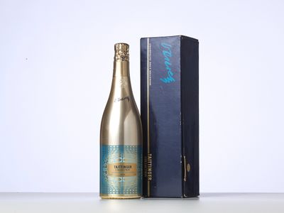 bottles of champagne and a blue box on a white surface