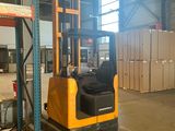 a forklift in a warehouse with boxes in the background