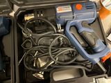 a blue and black corded drill in a black case