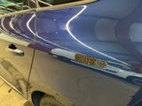 a close up of a car door handle with a sticker on it