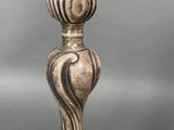 an image of a silver candle holder sitting on top of a table