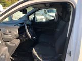the interior of a car with the door open and the driver ' s seat down