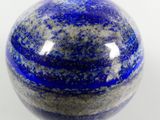 a picture of a blue and white marble ball on a white surface