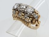 an image of a gold and diamond ring on a clear ring holder