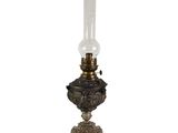 an old fashioned oil lamp with a glass shade on it