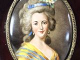 portrait of a woman in a yellow dress with a blue flower in her hair