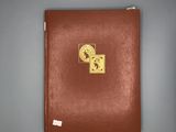 a brown book with a gold sticker on it