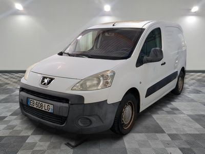 a small white van parked in a room with checkered floor