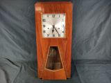 a wooden clock that is sitting on a table