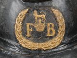 a close up of a fireman ' s hat with a gold emblem