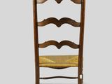 an image of a wooden chair with a woven seat and back
