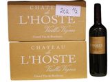 two boxes of wine and a bottle of wine sitting next to each other