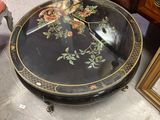 a black table with flowers on it in a room