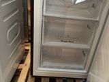 a refrigerator that is sitting on a pallet in the kitchen
