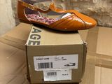a box that has a pair of shoes on top of it
