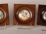 three framed portraits of a man and a woman are on display