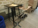 a small table with a chair next to it and a chair next to it