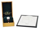 a wooden box with a watch inside of it