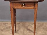 an old wooden table with a drawer on top of it on a wooden floor